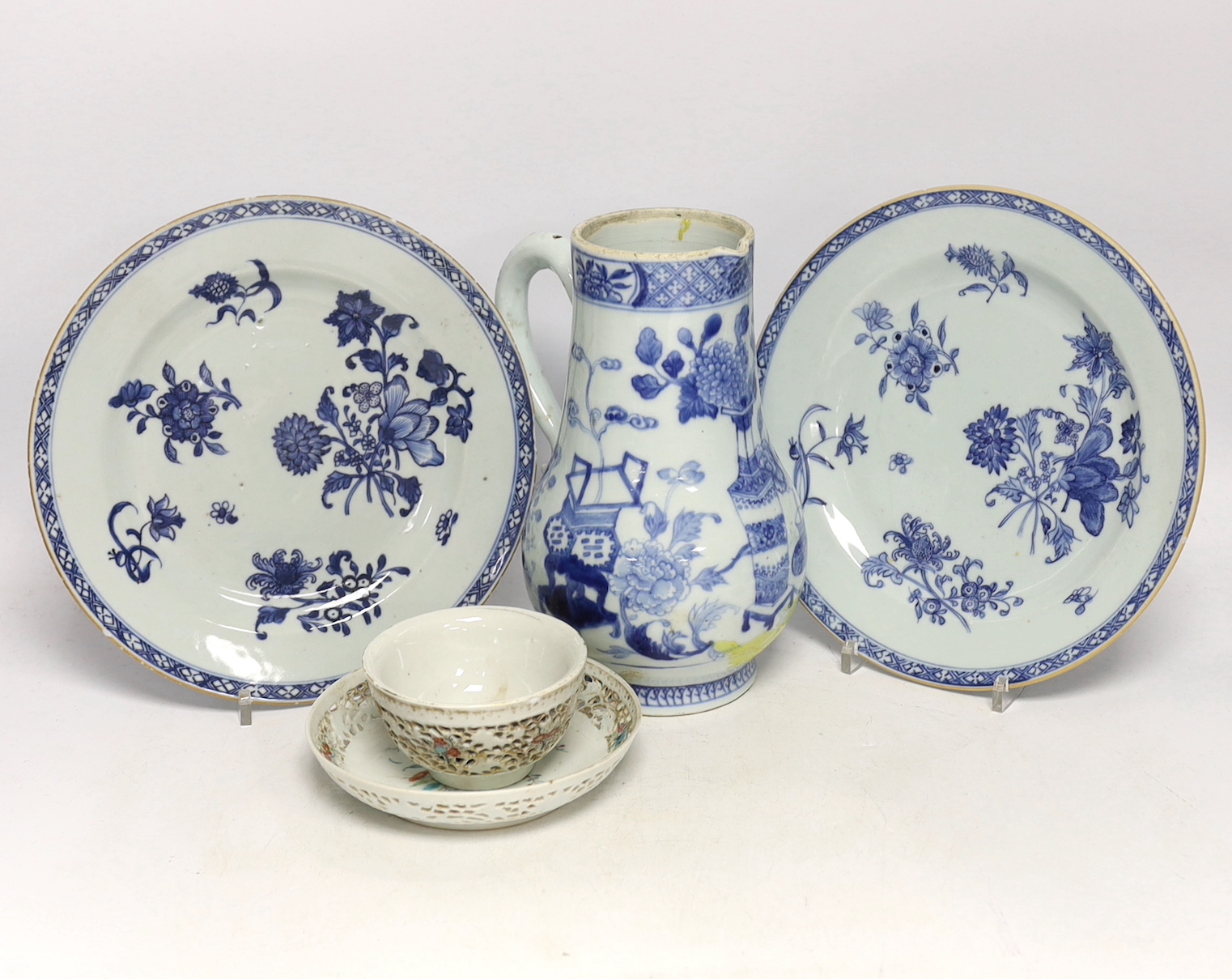 A Chinese 18th century reticulated double walled tea bowl and saucer, two blue and white plates and a jug (5)